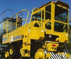  A Trackmobile Viking railcar pulling cars on a railway.A Trackmobile Viking railcar pulling cars on a railway.